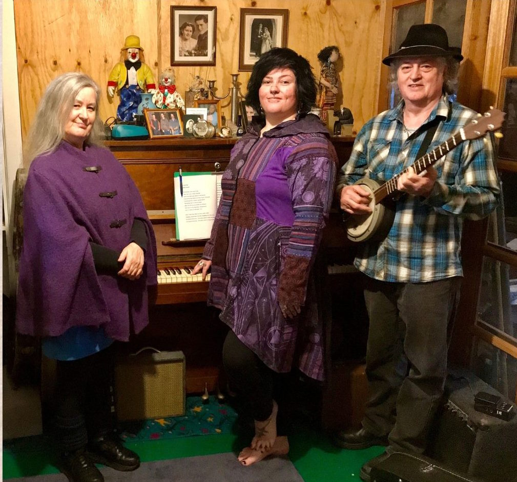 Jensen family stands in front of a piano 